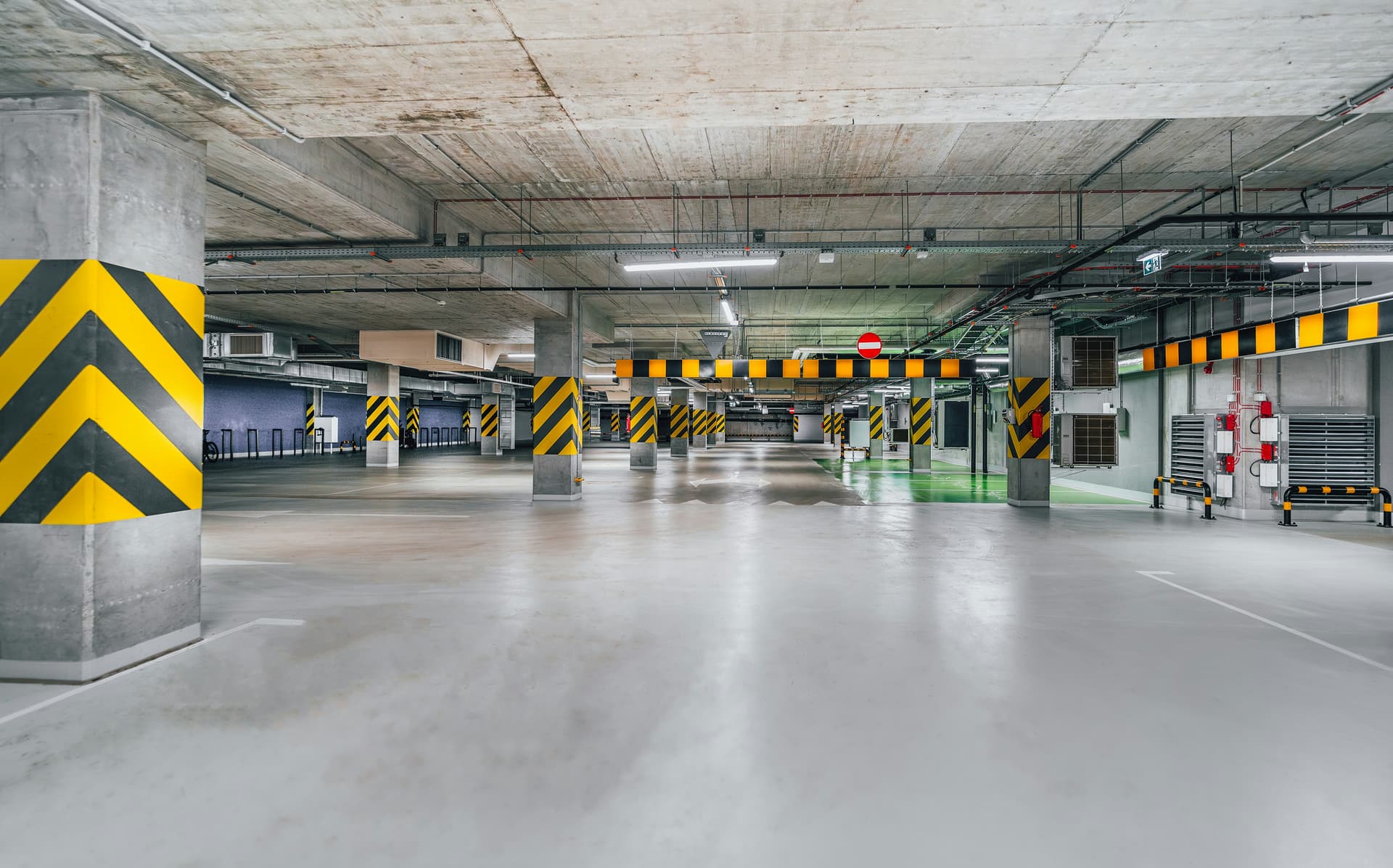 Commercial parking structure — sealed grey epoxy with chevron safety markings
