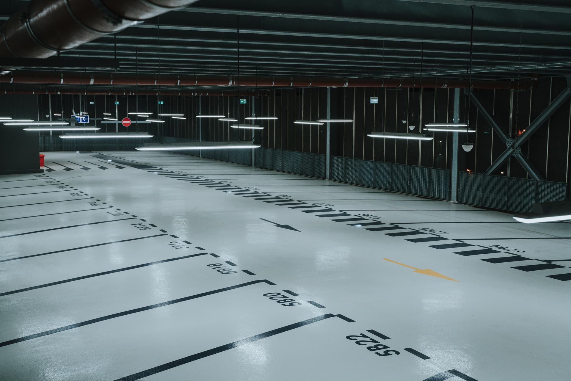 Parking structure with grey epoxy and dramatic pendant lighting