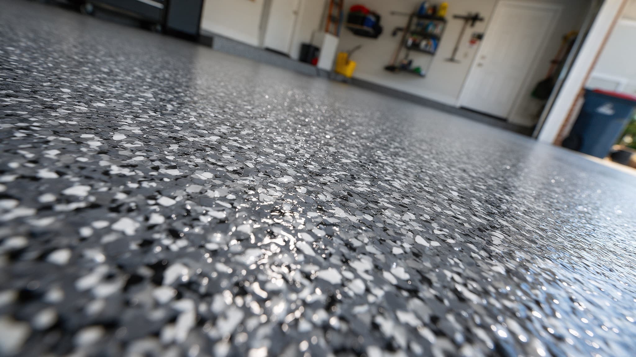 Macro view of charcoal and white flake chips suspended under a clear gloss topcoat