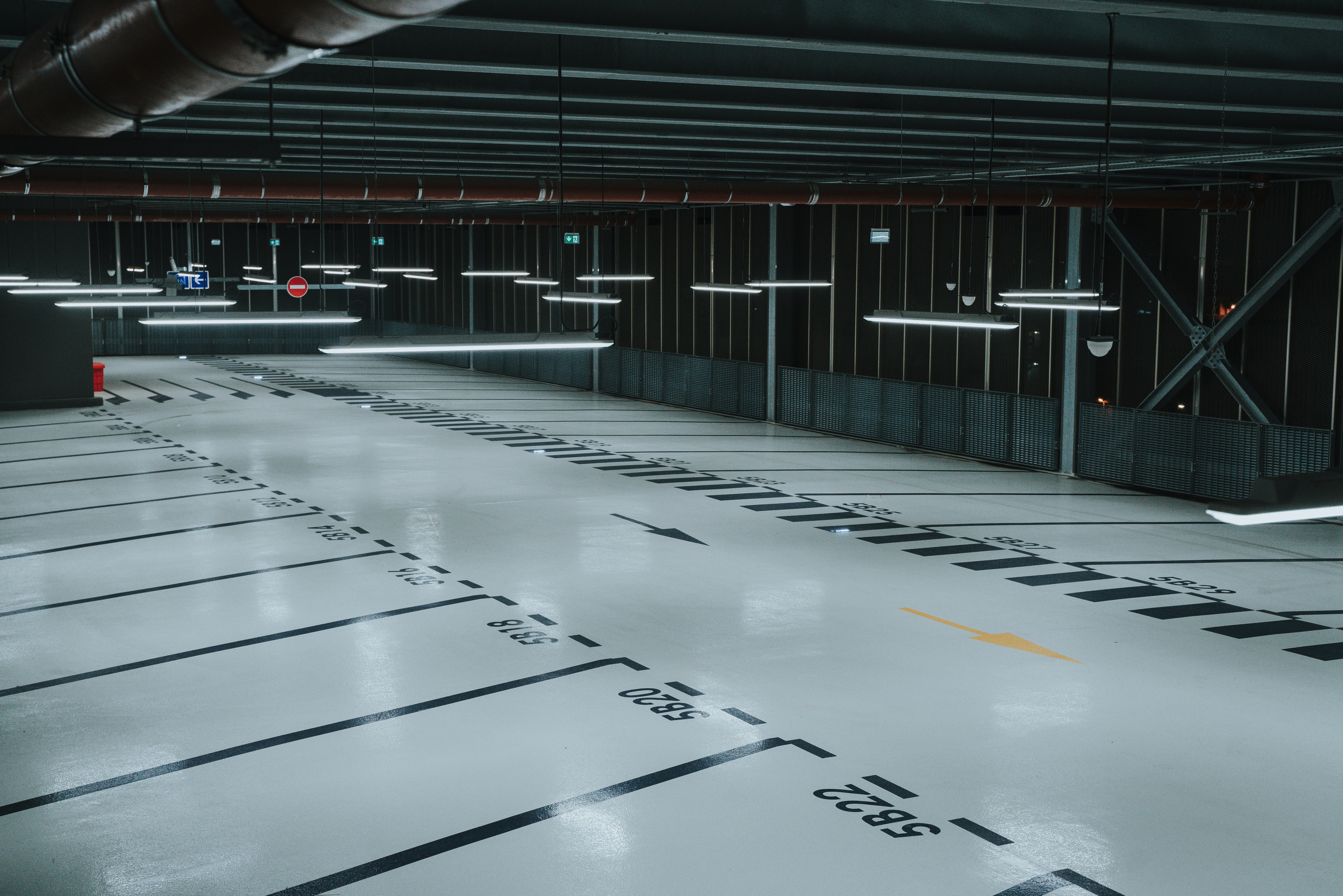 Parking structure with grey epoxy and dramatic pendant lighting